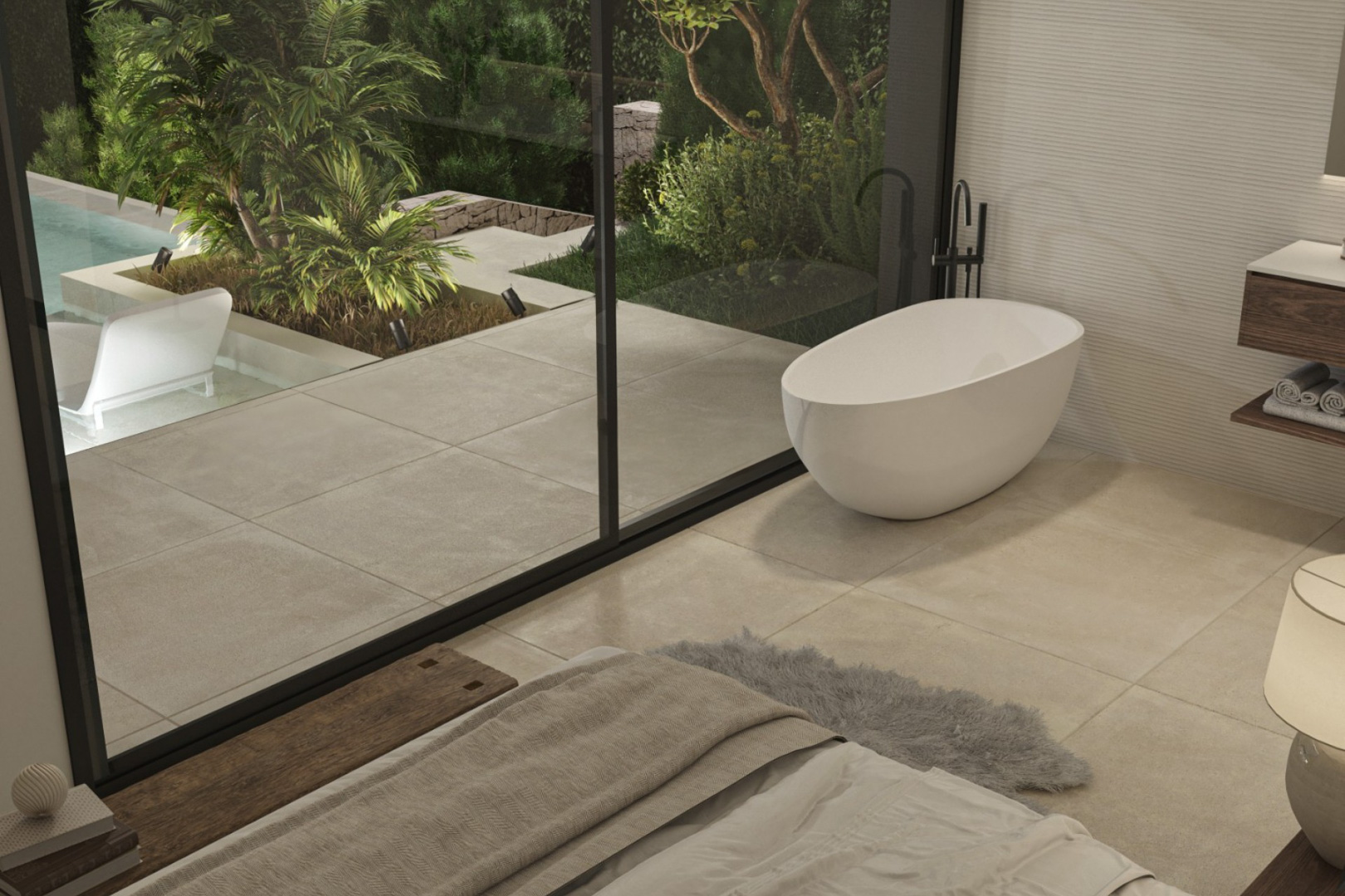 Dormitorio principal con bañera exenta de diseño y ventanales de suelo a techo que conectan con la terraza privada y el jardín mediterráneo.