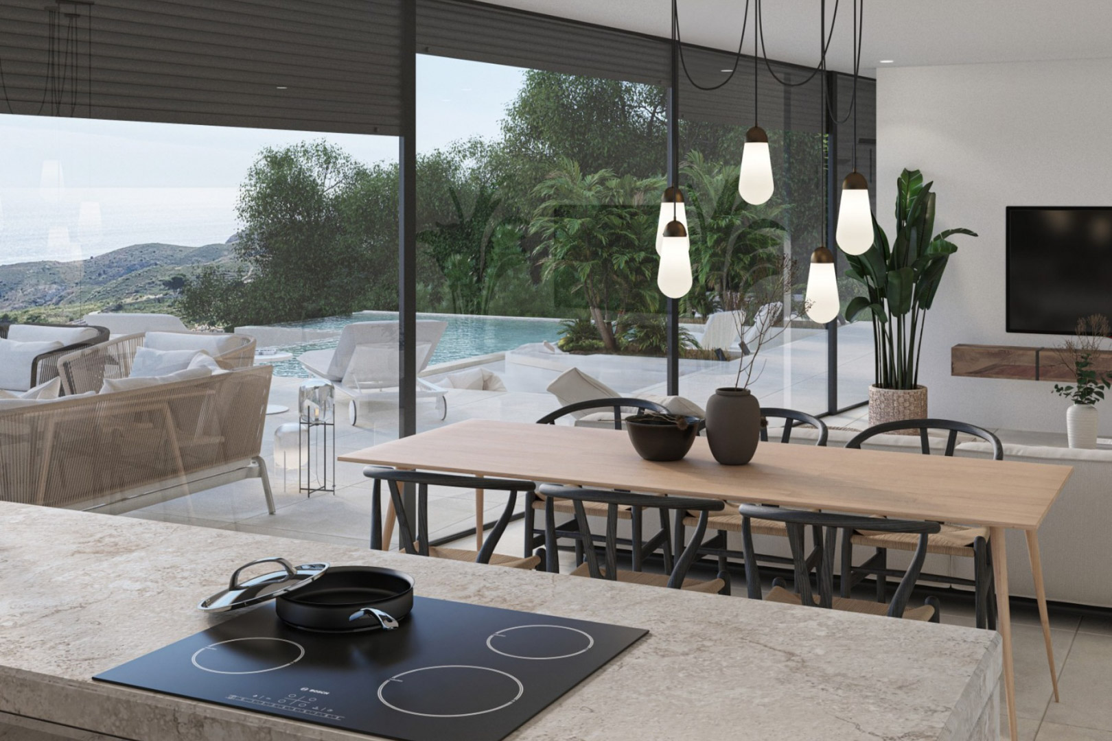 Salón-comedor abierto con cocina de isla en piedra, iluminación de diseño y amplios ventanales con vistas directas a la piscina infinita y el entorno natural.
