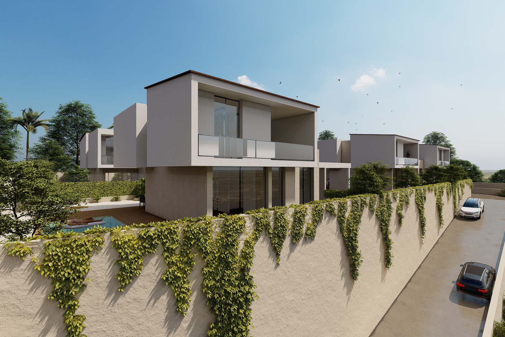 Fachada exterior de villas modernas con balcones de cristal y muros perimetrales revestidos de hiedra natural. El diseño destaca por sus líneas rectas y volúmenes blancos contemporáneos.