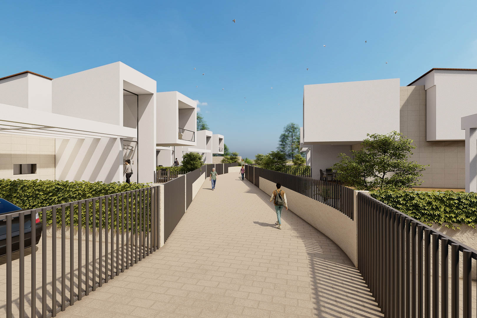Vial de acceso peatonal pavimentado entre villas de diseño cúbico blanco, con vallado perimetral oscuro y setos integrados bajo un cielo despejado.