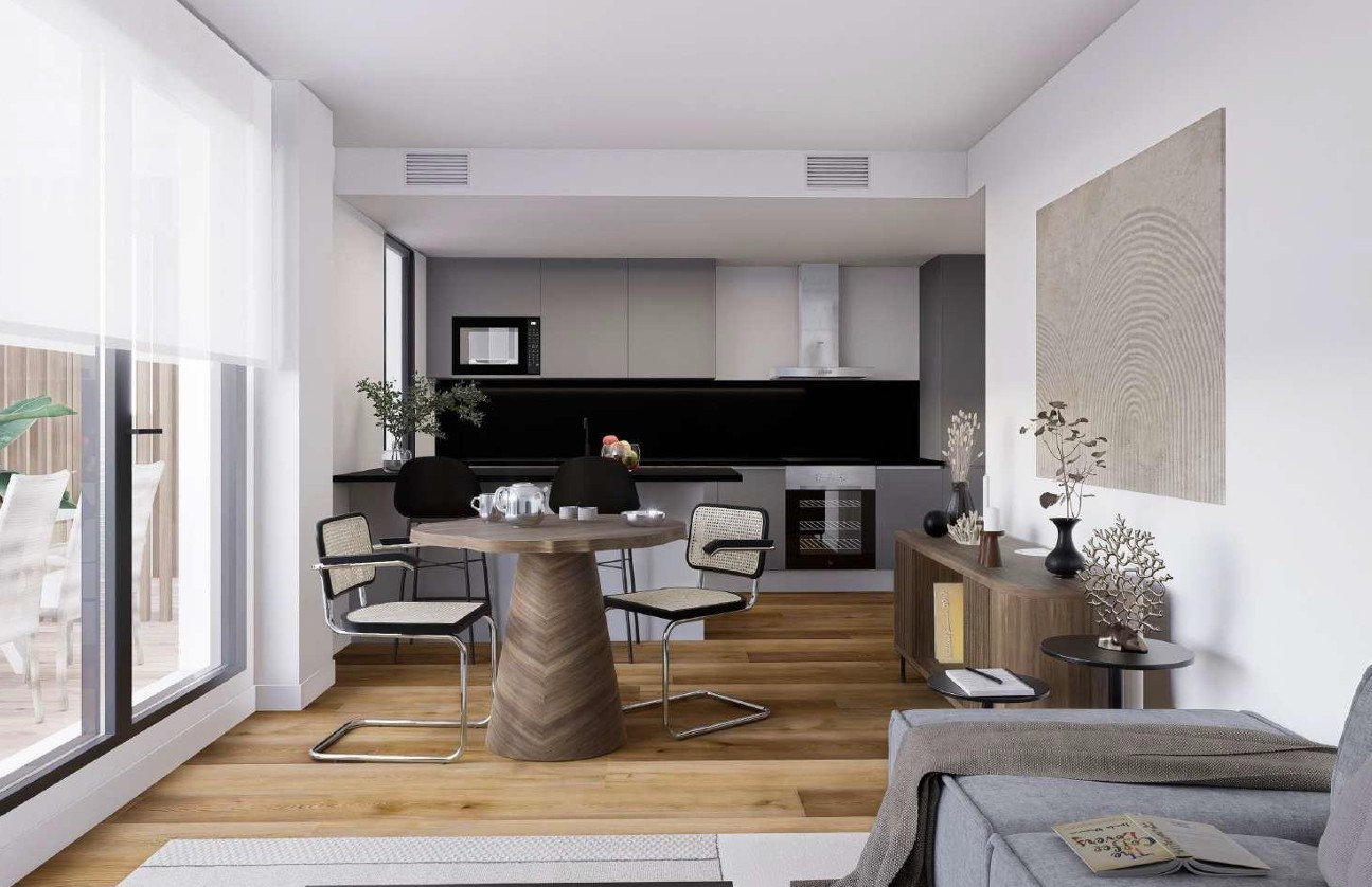 Salón-comedor diáfano con cocina de diseño en tonos grises, suelos de madera Porcelanosa y amplios ventanales que integran la terraza al espacio interior.
