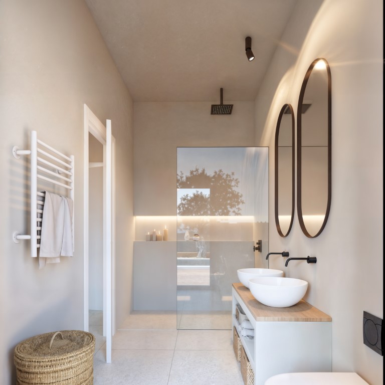 Baño moderno con lavabo doble sobre encimera de madera, grifería negra empotrada, espejos ovalados retroiluminados y ducha italiana con mampara de cristal.