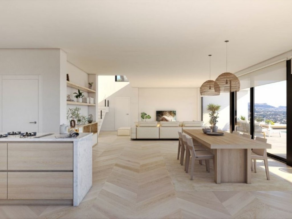 Salón-comedor diáfano con suelo de madera en espiga, cocina con isla de mármol y amplios ventanales que conectan con la terraza y vistas panorámicas.