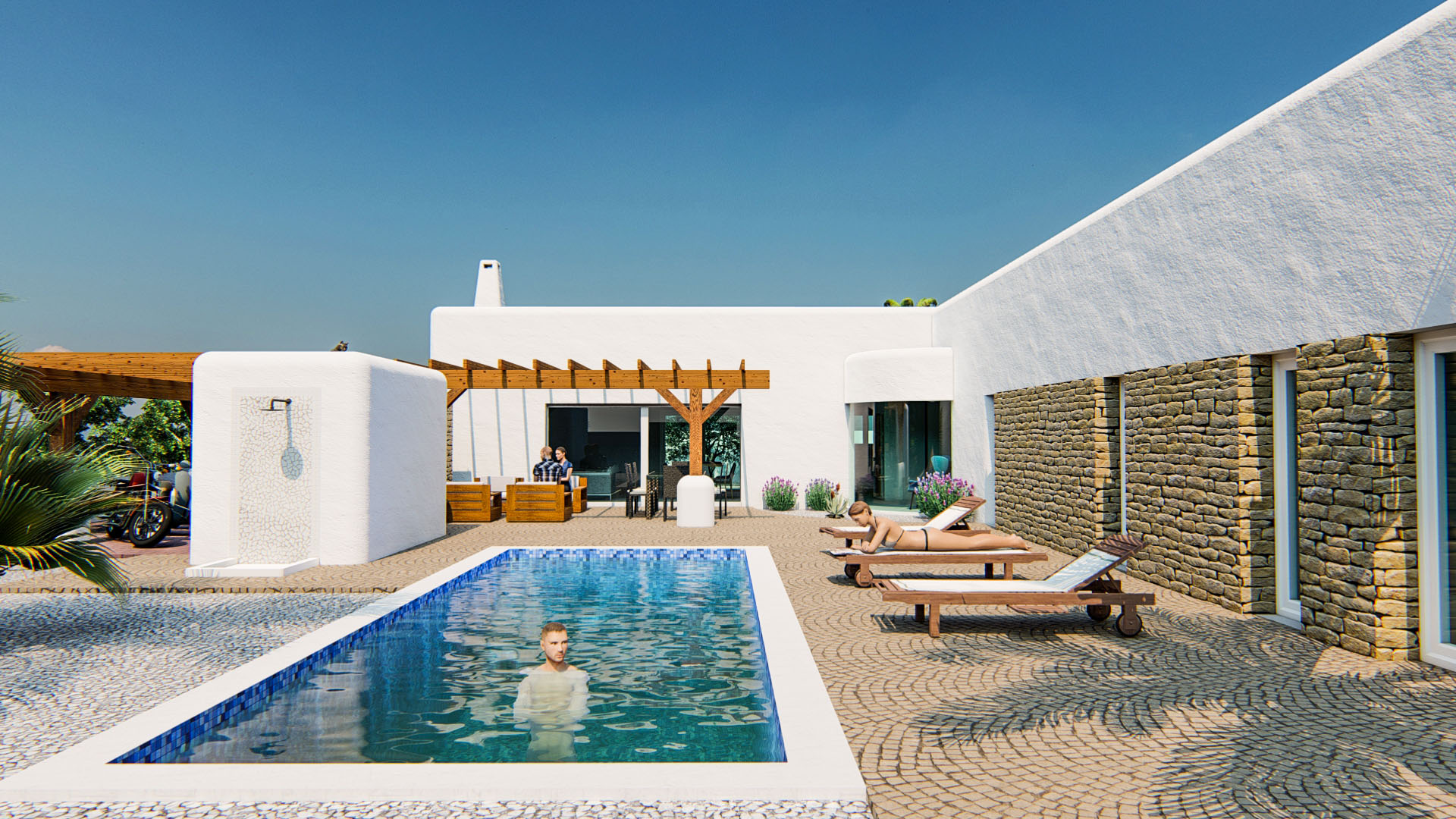 Exterior de estilo ibicenco con piscina rectangular, terraza de adoquines, ducha exterior y fachada que combina revoco blanco con muros de piedra natural.
