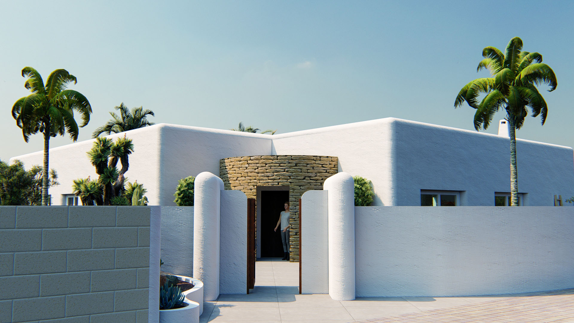 Fachada exterior de estilo ibicenco con muros blancos redondeados y entrada principal enmarcada por un muro curvo de piedra natural.