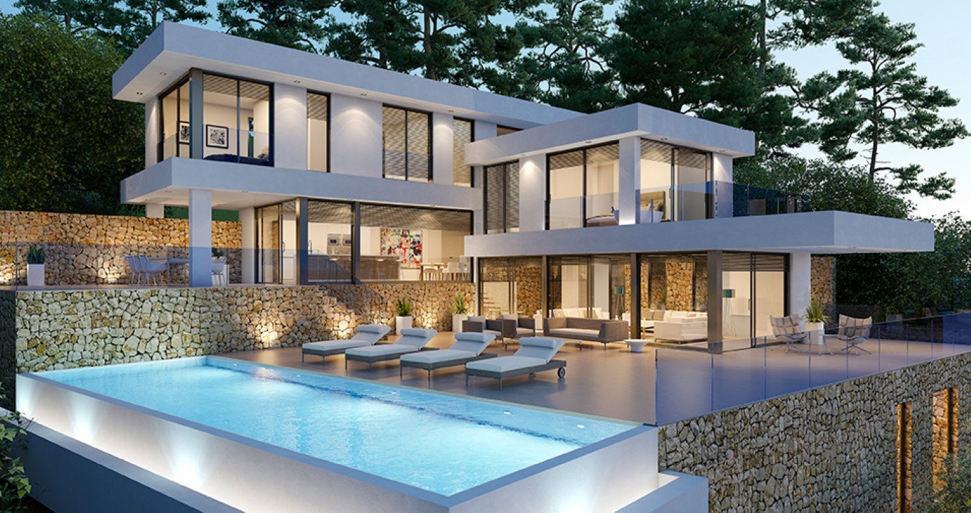 Vista exterior nocturna de la villa con piscina iluminada, muros de piedra natural y amplias terrazas con barandillas de cristal que conectan con el interior.