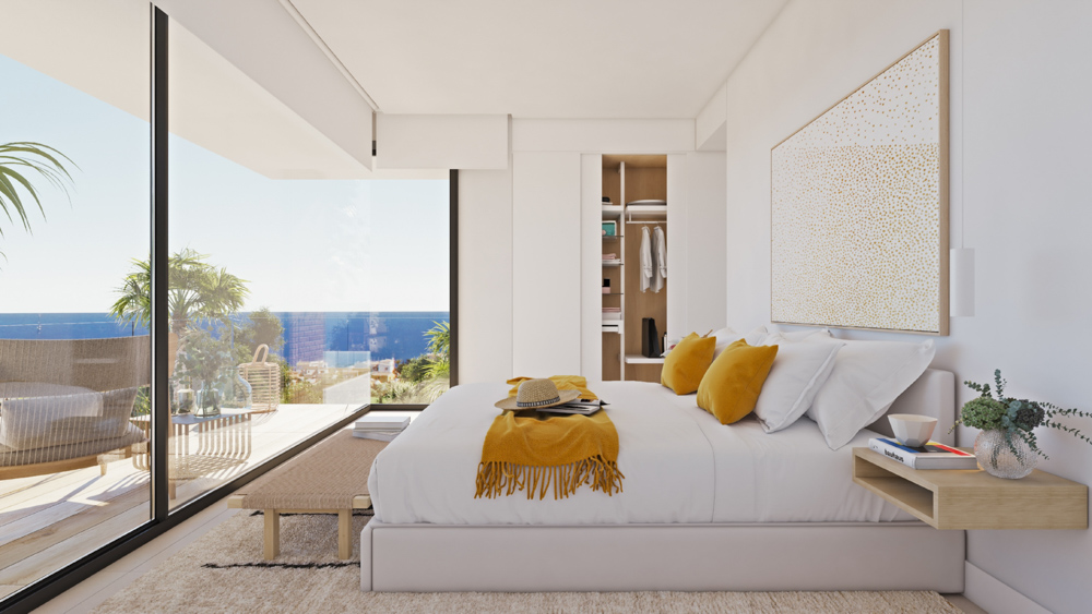 Dormitorio con ventanales de suelo a techo, vistas al Mediterráneo, armario empotrado con acabados en madera y acceso directo a la terraza exterior.