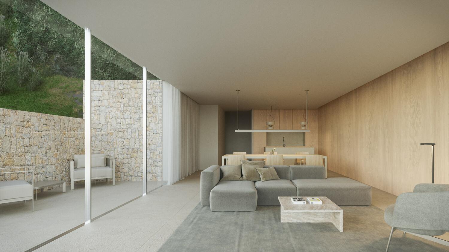 Salón de planta abierta con sofás grises, paredes paneladas en madera clara y grandes ventanales que conectan con un patio exterior de piedra natural.