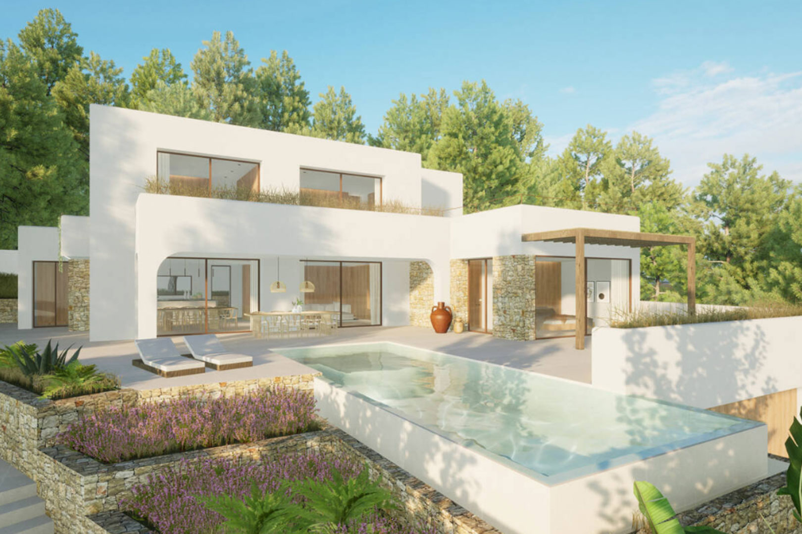 Vista exterior de la villa con piscina rectangular, terraza con tumbonas y jardín con muros de piedra.