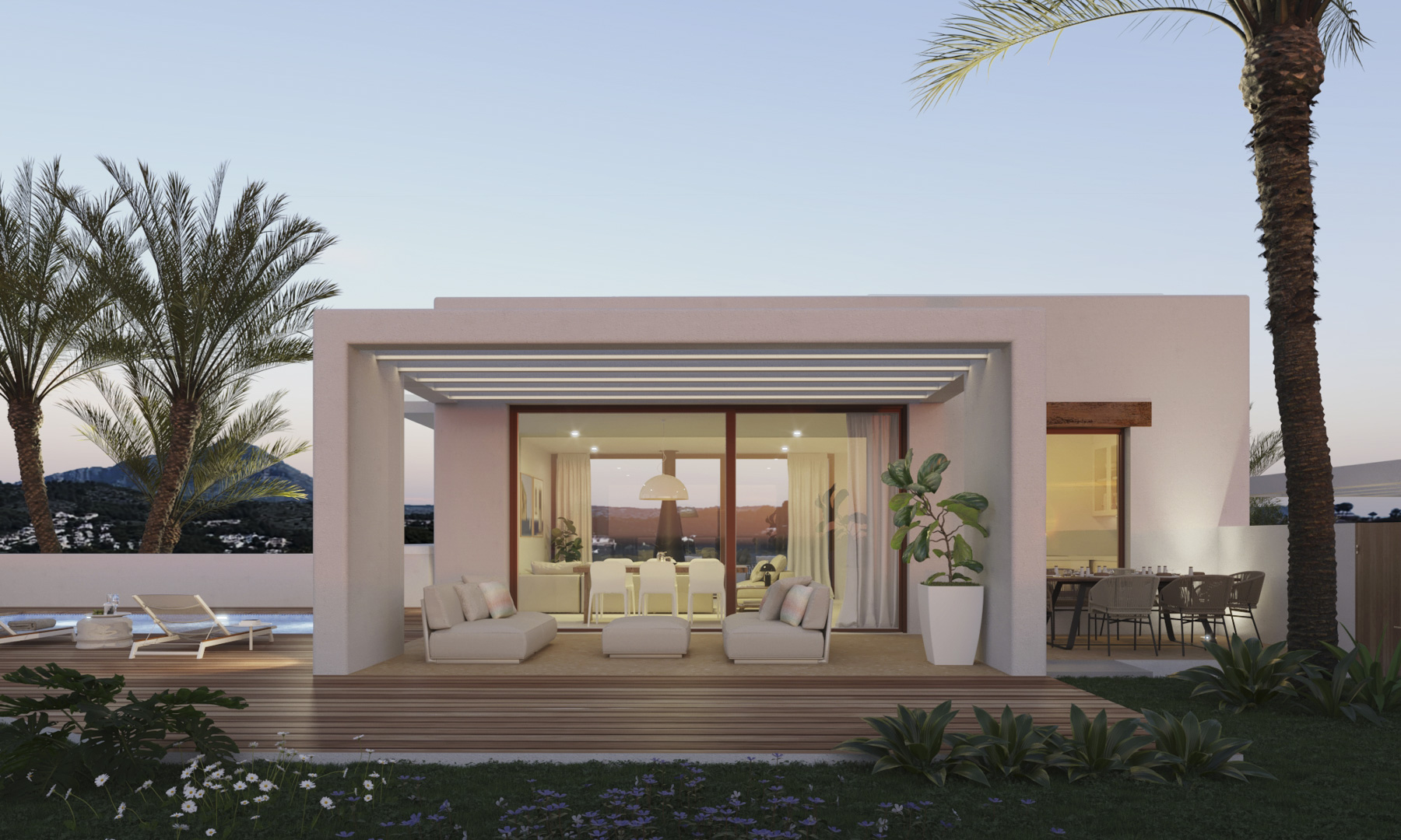 Fachada blanca de estilo ibicenco con terraza cubierta, tarima de madera y vistas al Montgó. Incluye zona de estar exterior, comedor y piscina integrada en el jardín.