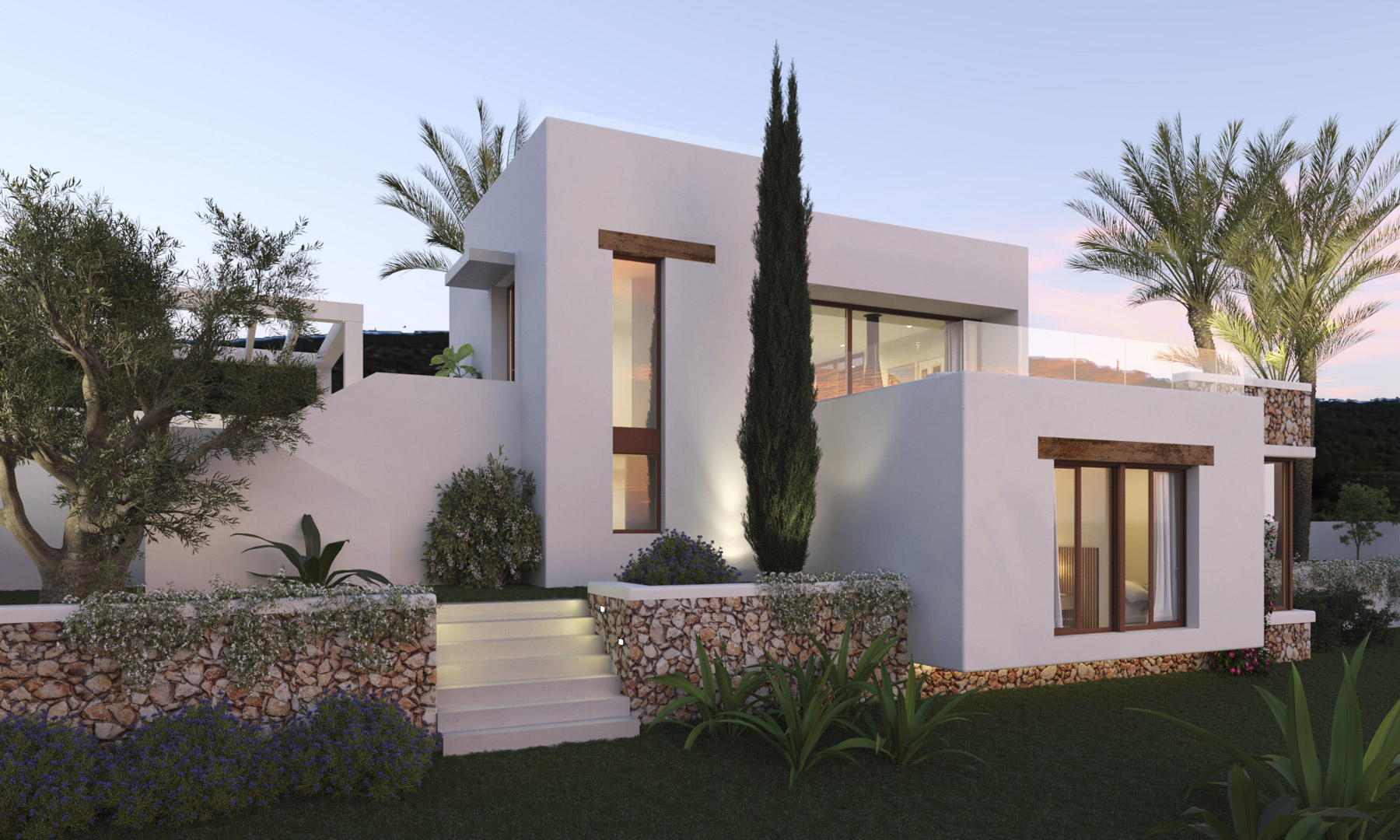 Fachada de estilo ibicenco con muros de piedra seca, carpintería de madera y una escalera exterior iluminada que conecta los niveles del jardín mediterráneo.