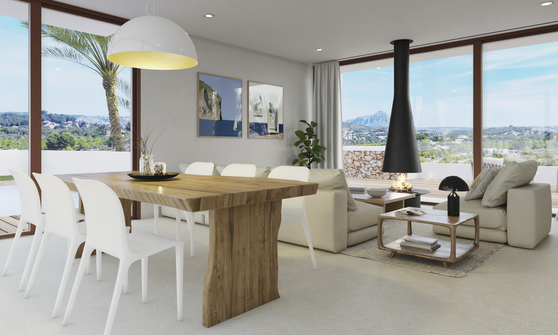Salón-comedor diáfano con mesa de madera maciza, chimenea suspendida de diseño negro y amplios ventanales con vistas al Montgó y al paisaje de Jávea.