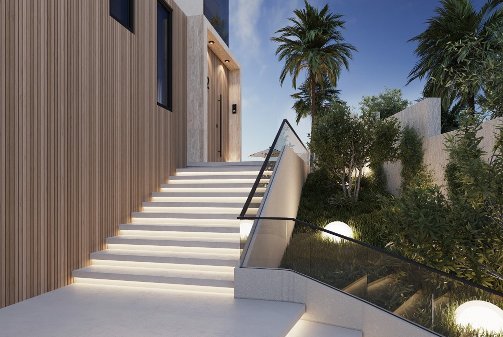 Entrada moderna con escaleras iluminadas y revestimiento de madera vertical. Jardín lateral con iluminación esférica.
