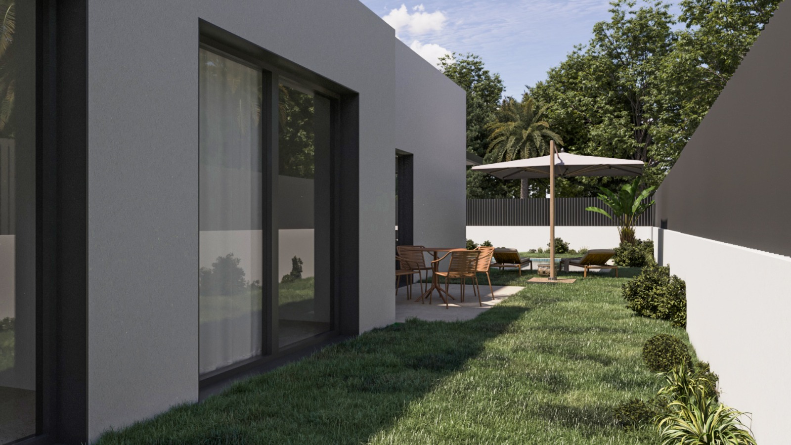 Exterior de la villa con fachada minimalista, grandes ventanales y zona de jardín privado con terraza pavimentada, mobiliario de exterior y tumbonas bajo sombrilla.