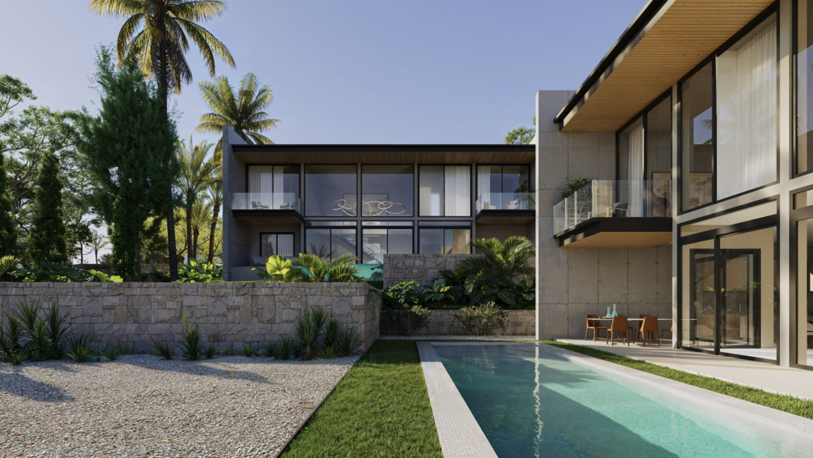 Fachada moderna con grandes ventanales, piscina rectangular y muros de piedra natural integrados en un jardín con palmeras y zonas de grava.
