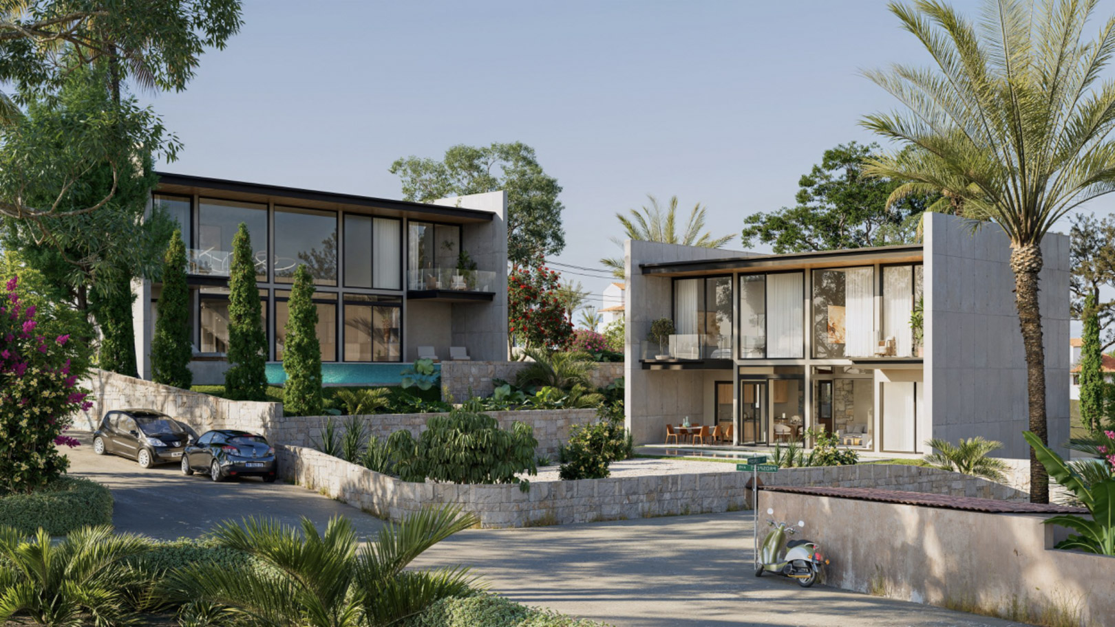 Vista exterior de las villas con fachadas de hormigón, amplios ventanales y jardines mediterráneos delimitados por muros de piedra natural en Calpe.