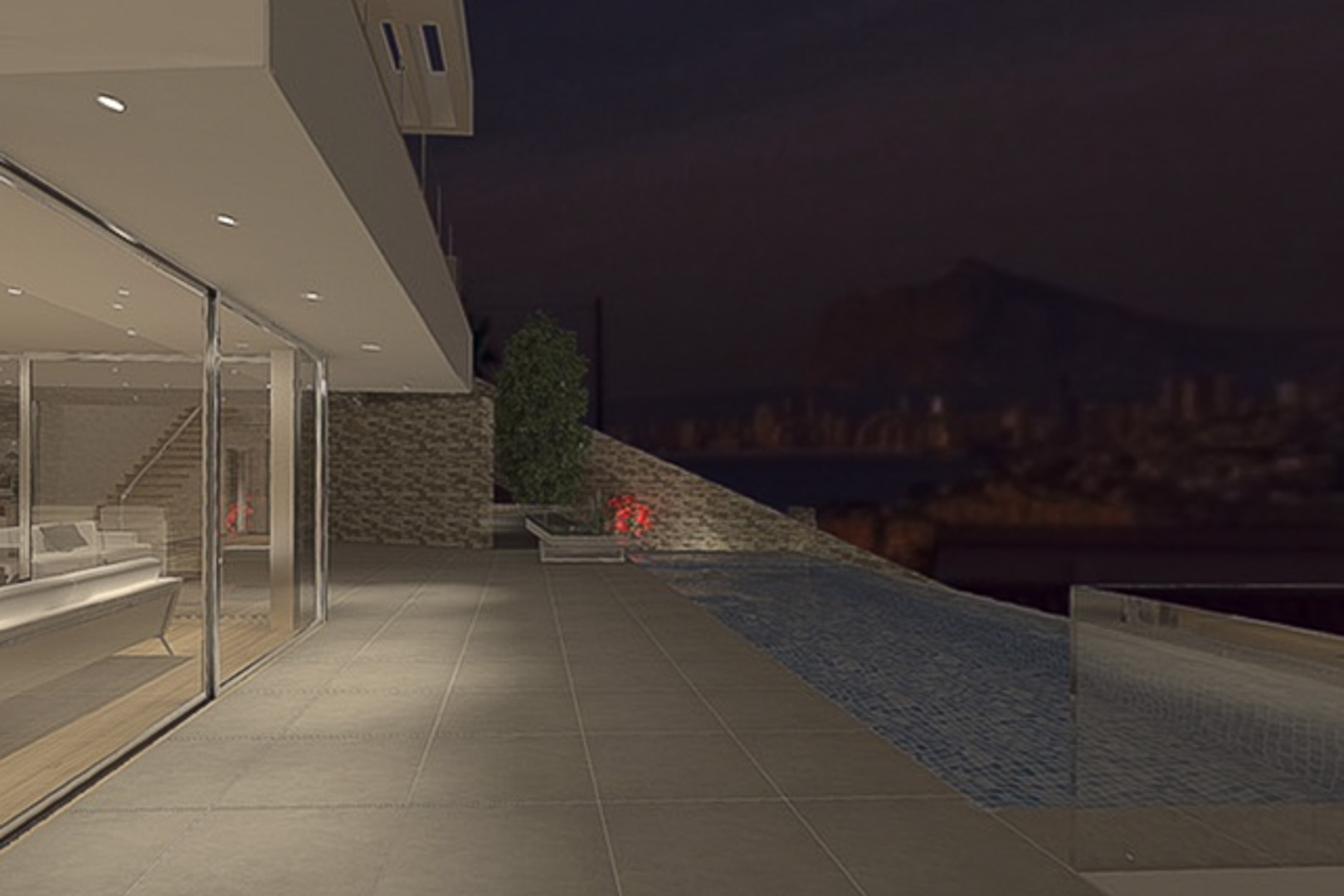 Terraza nocturna con piscina infinita y gres porcelánico, integrada al salón mediante amplios ventanales y vistas despejadas hacia la costa iluminada.