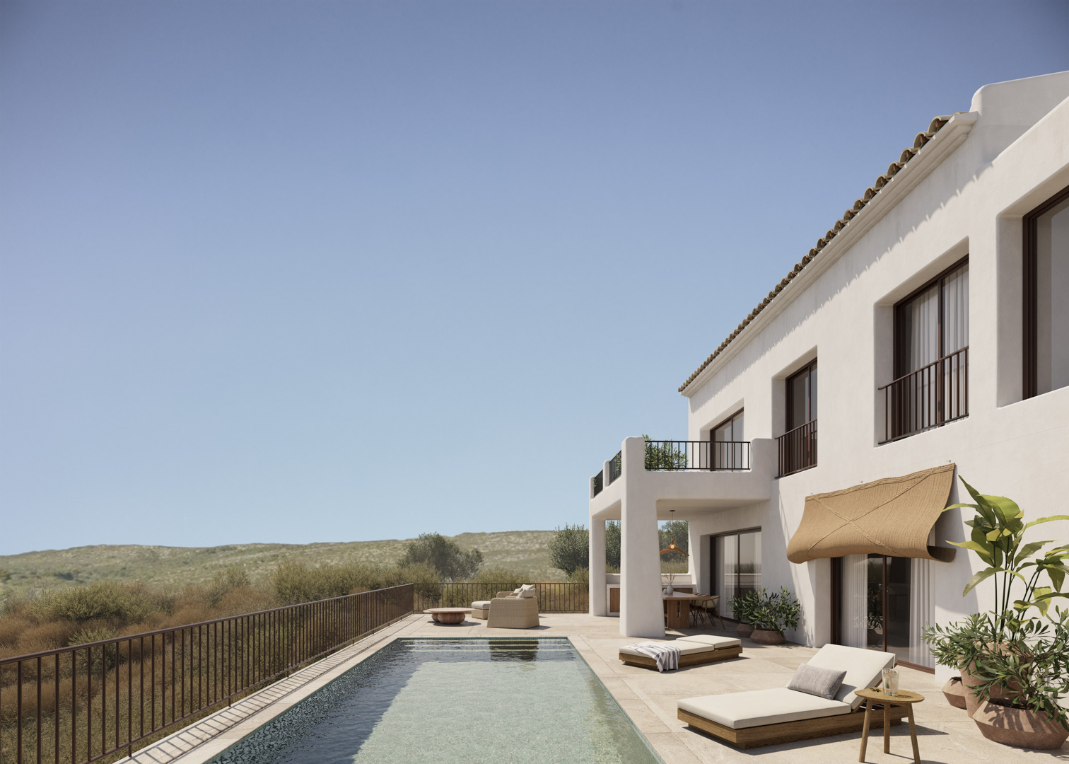 Fachada blanca de estilo ibicenco con piscina rectangular, terraza de piedra natural y zona de estar exterior con vistas panorámicas al valle de Jalón.