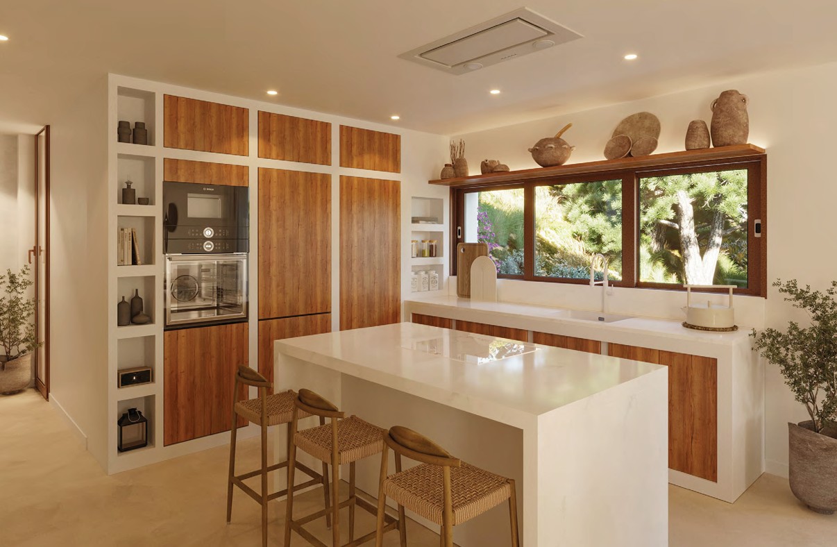 Cocina moderna con isla central, armarios de madera y vistas al jardín.