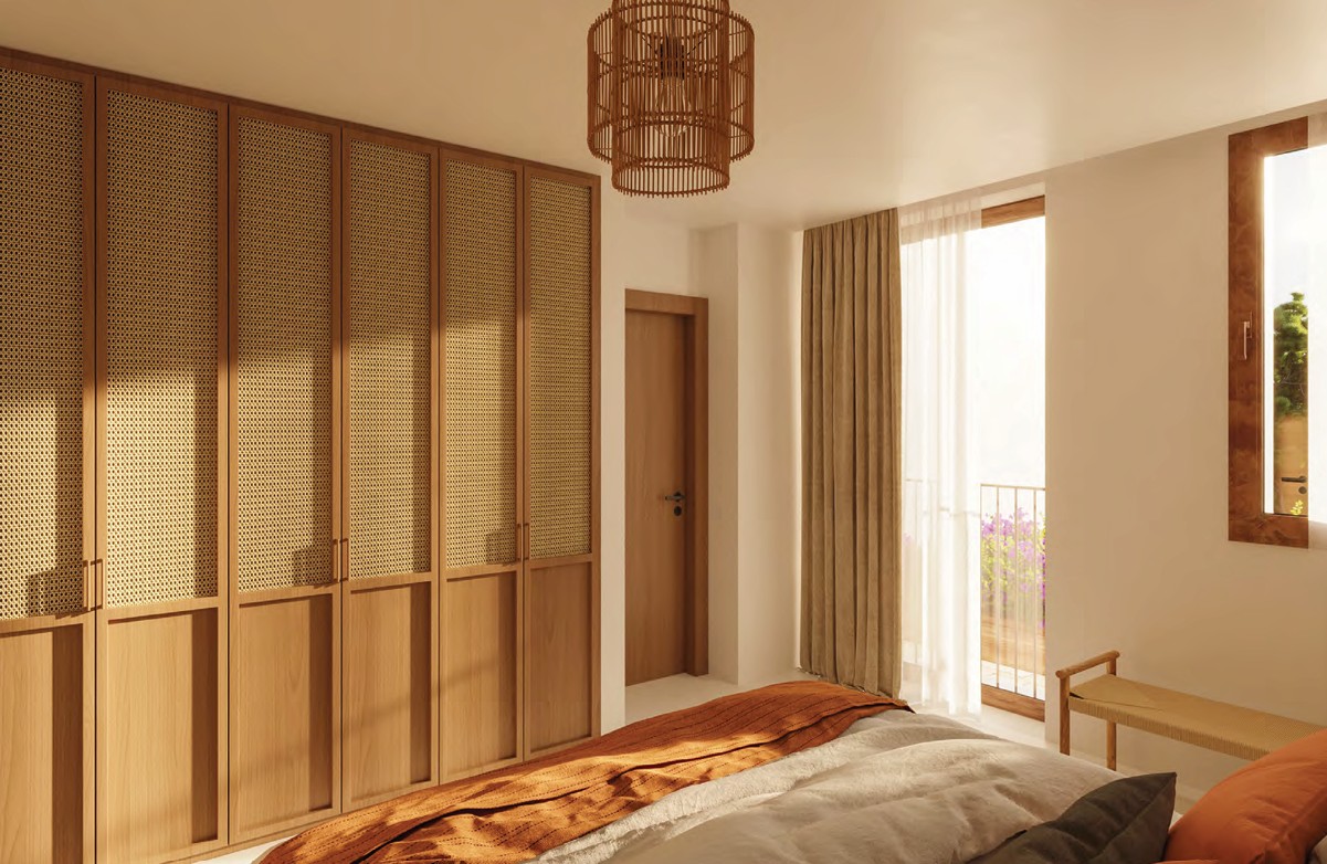 Dormitorio con armario de madera y lámpara colgante de mimbre.