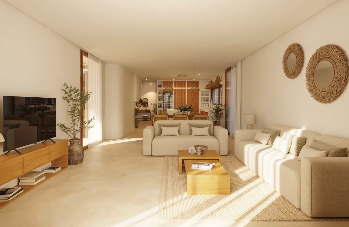 Salón luminoso con sofás beige, mesa de centro de madera y decoración natural.