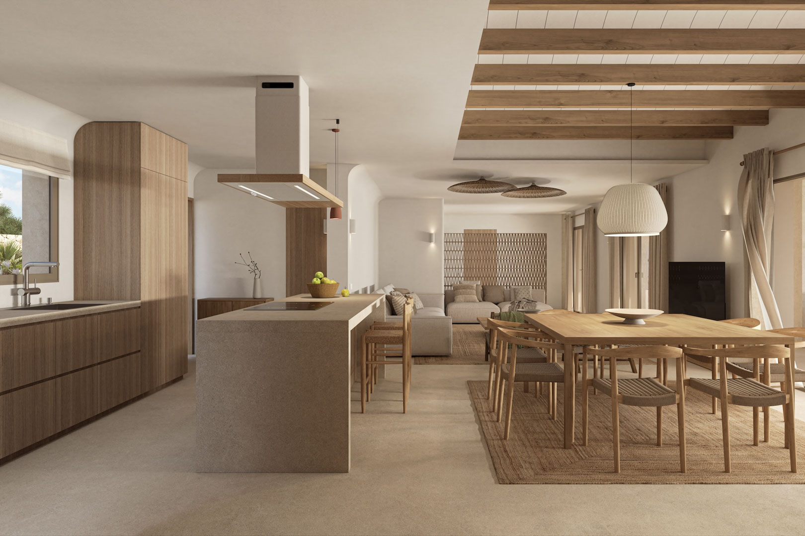 Espacio diáfano que integra cocina con isla de piedra, comedor de madera y salón, resaltando las vigas vistas y el uso de materiales naturales en tonos neutros.