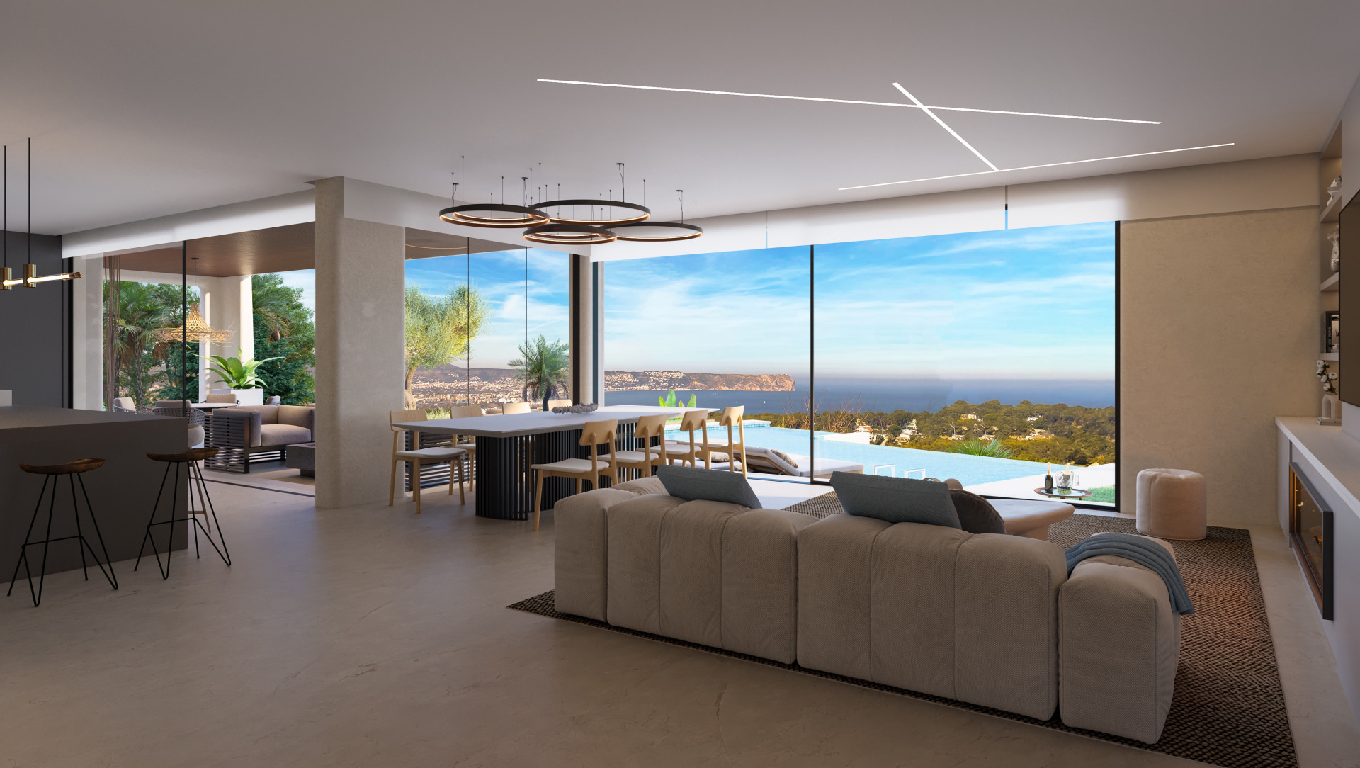 Amplio salón con vistas panorámicas al mar, cocina abierta y mobiliario moderno en Jávea.