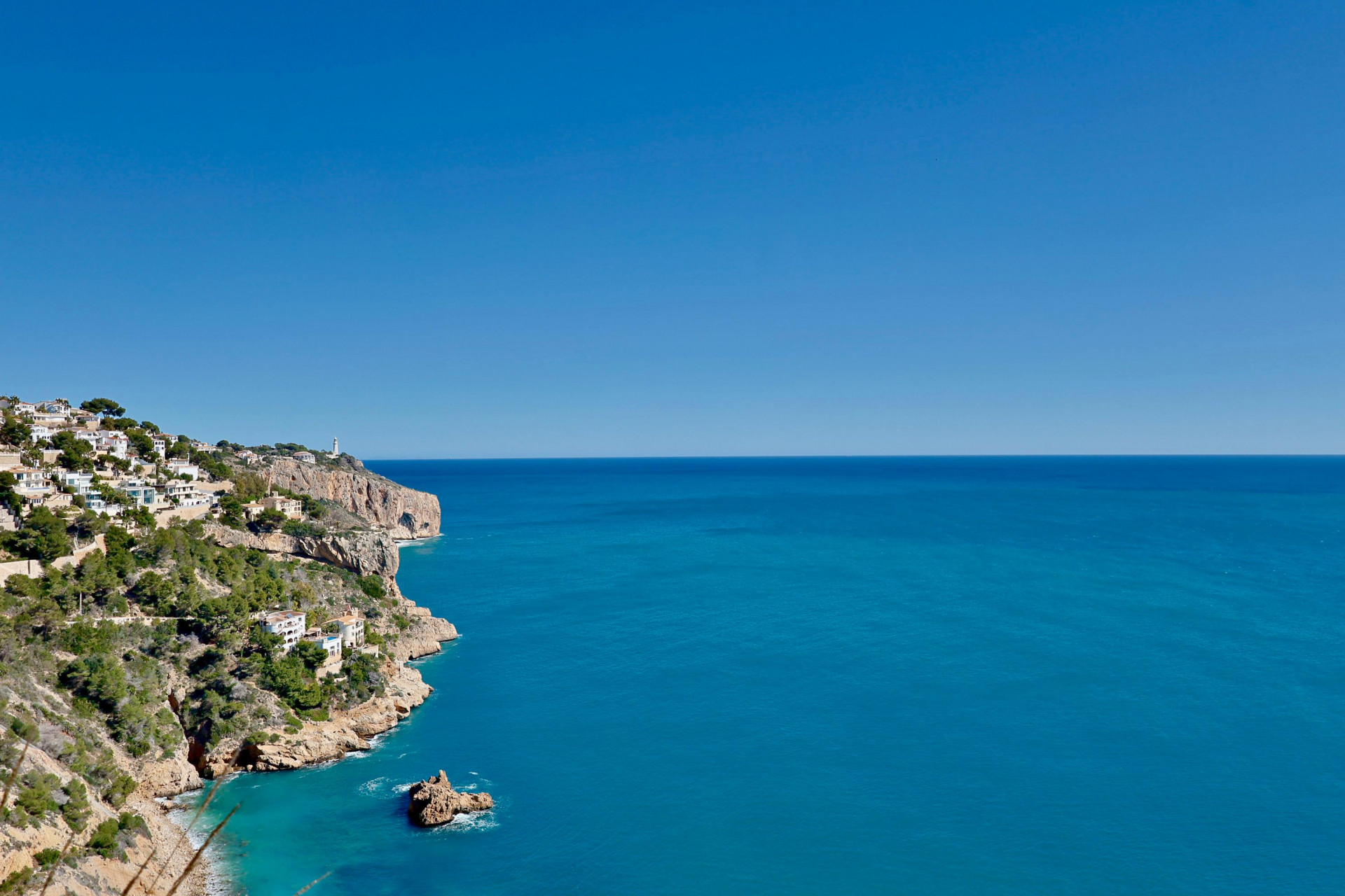 Vista panorámica de la costa rocosa de Jávea y el mar Mediterráneo azul.