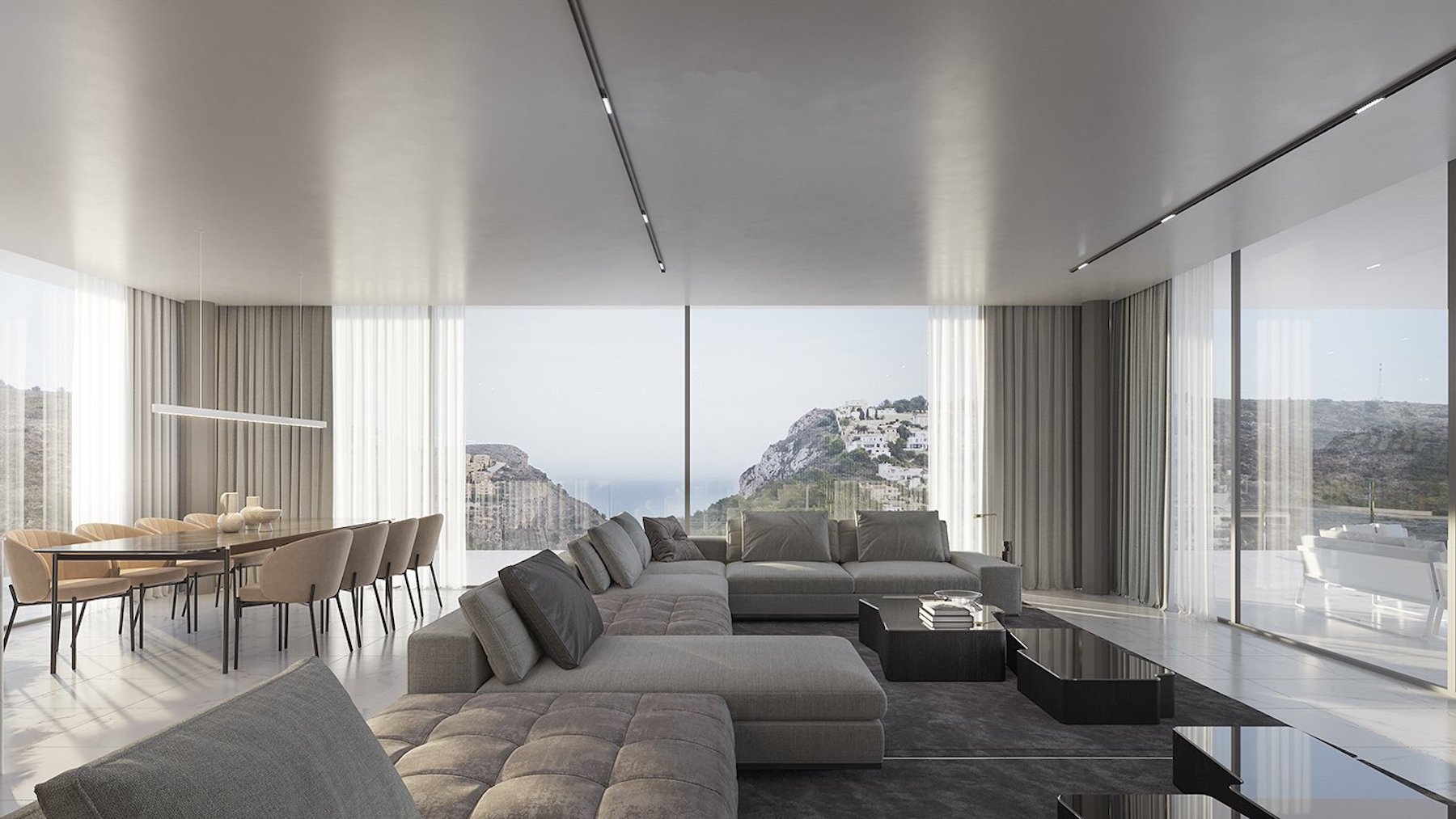 Salón comedor diáfano con amplios ventanales de suelo a techo que ofrecen vistas panorámicas al mar y la costa, equipado con mobiliario minimalista en tonos neutros.