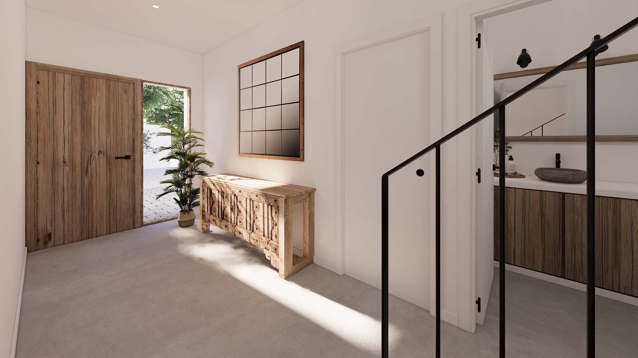 Vestíbulo de entrada con puerta de madera natural, consola tallada y suelos de microcemento. Incluye acceso a un baño con lavabo de piedra y carpintería negra.