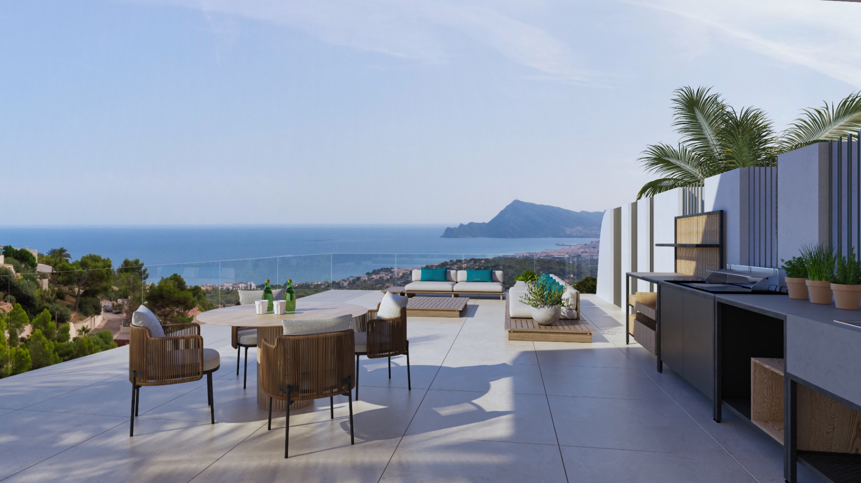 Terraza exterior con cocina de verano equipada, zona de comedor y salón lounge. Ofrece vistas panorámicas al mar Mediterráneo y la costa de Altea tras una barandilla de cristal.
