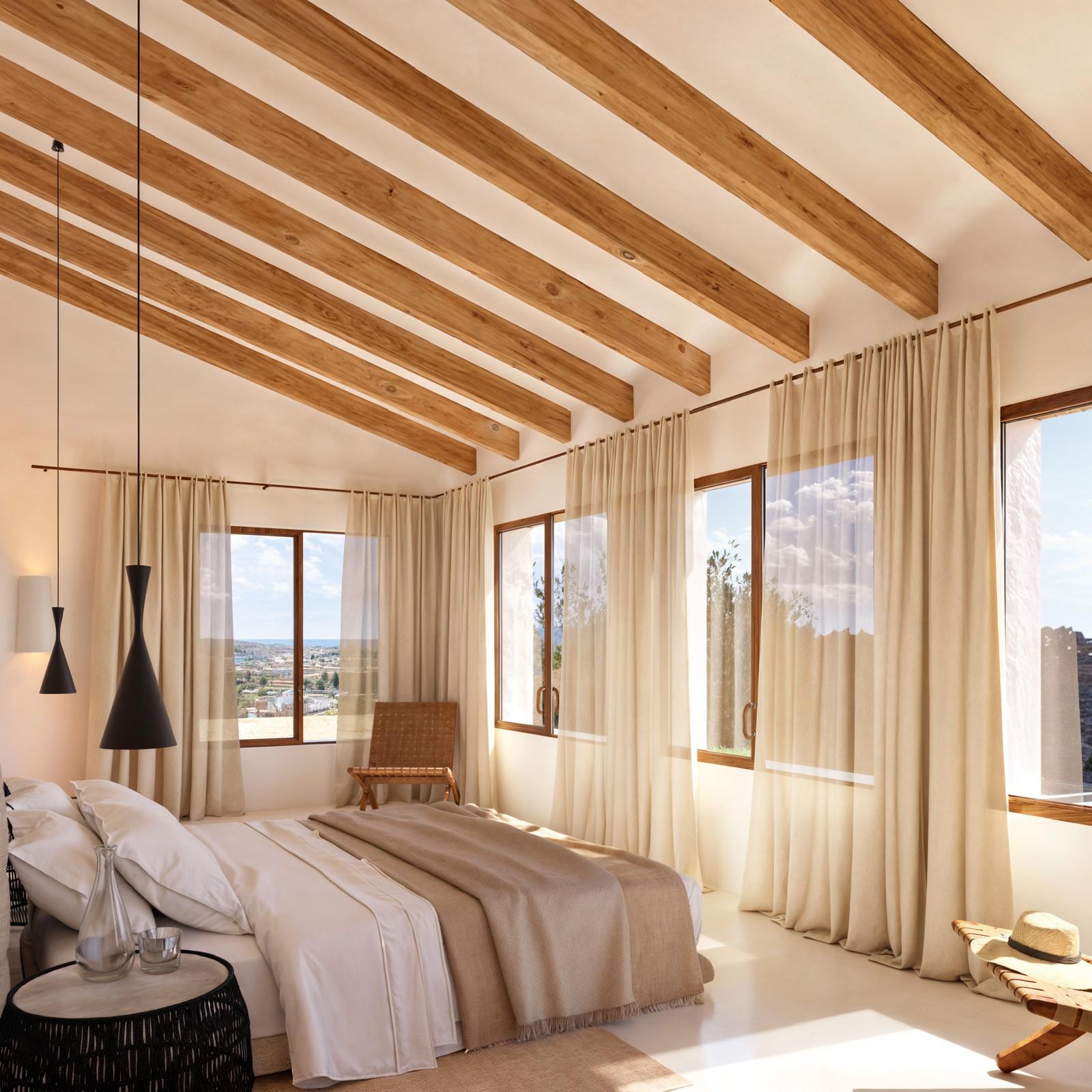 Dormitorio con vigas de madera vista, amplios ventanales con carpintería de madera y abundante luz natural que resalta las vistas al mar.