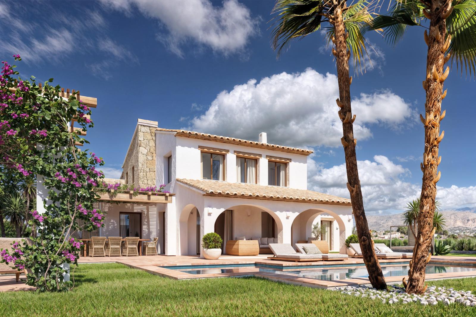 Fachada de la villa con porche de arcos, piscina rodeada de césped y zona de comedor bajo pérgola de madera con buganvillas, destacando los muros de piedra natural.
