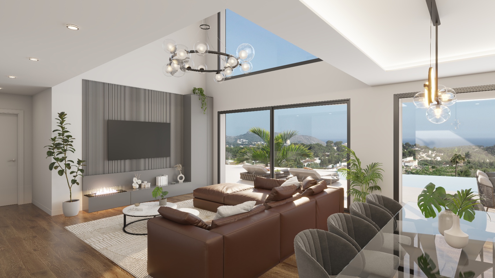 Salón de concepto abierto con techos de doble altura, chimenea integrada en panel gris y amplios ventanales con vistas panorámicas al mar y la montaña.