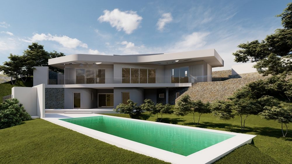 Vista exterior de la villa con fachada blanca, muros de piedra natural y piscina rectangular integrada en un jardín de césped con flora autóctona.