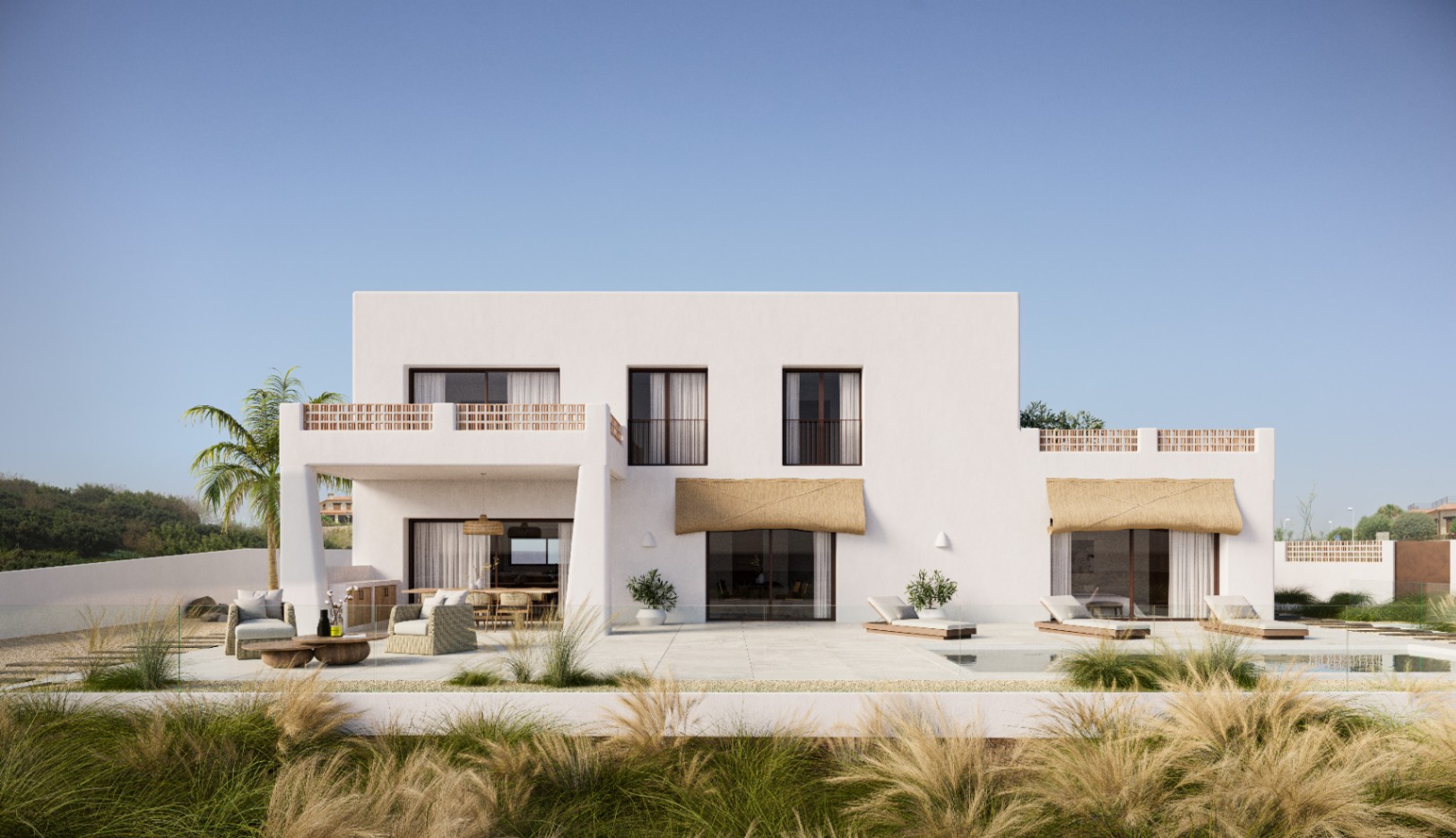 Fachada exterior de la villa con arquitectura blanca minimalista, amplia terraza de piedra clara, zona de estar exterior y balcones con celosías de terracota.