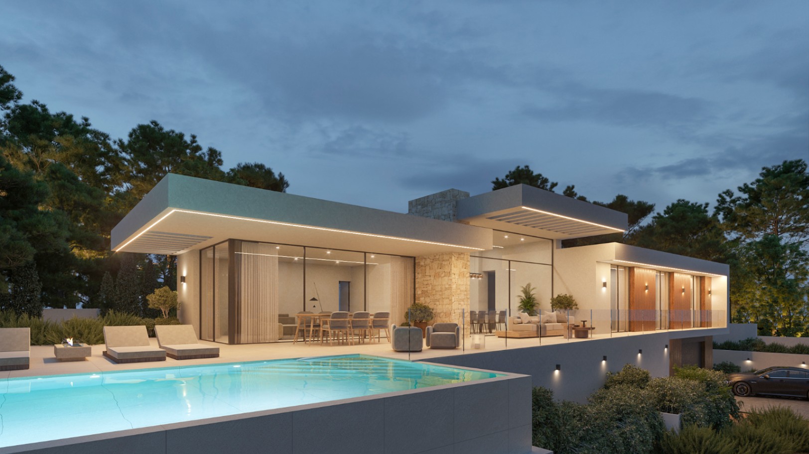 Vista exterior nocturna de la villa con piscina infinita, fachadas de piedra natural y madera, y amplios ventanales que integran el salón con la terraza iluminada.