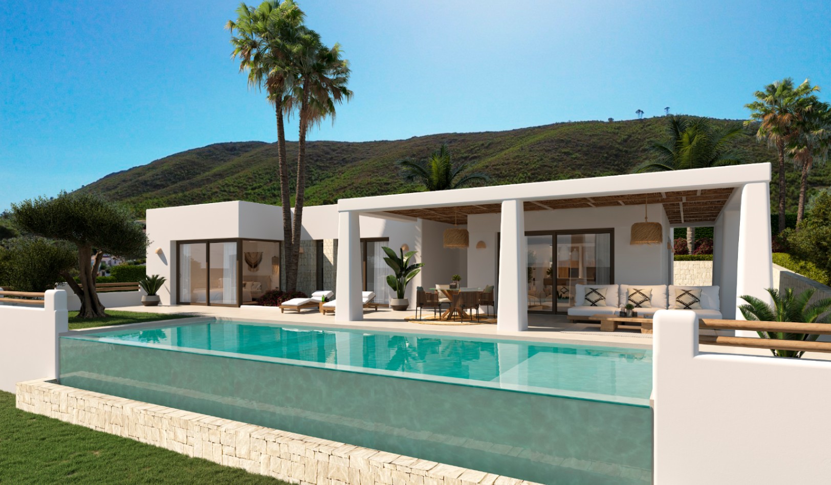 Exterior de la villa con piscina de borde de cristal, porche cubierto con techo de cañizo y arquitectura blanca de estilo ibicenco bajo el sol mediterráneo.