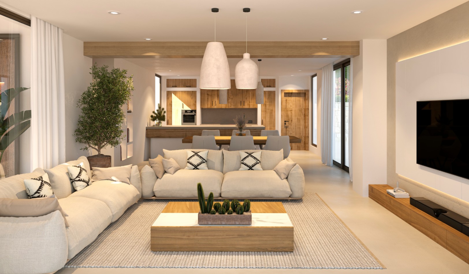 Salón diáfano de estilo ibicenco con vigas de madera, zona de estar integrada y cocina al fondo. Destacan la iluminación indirecta y los amplios ventanales.