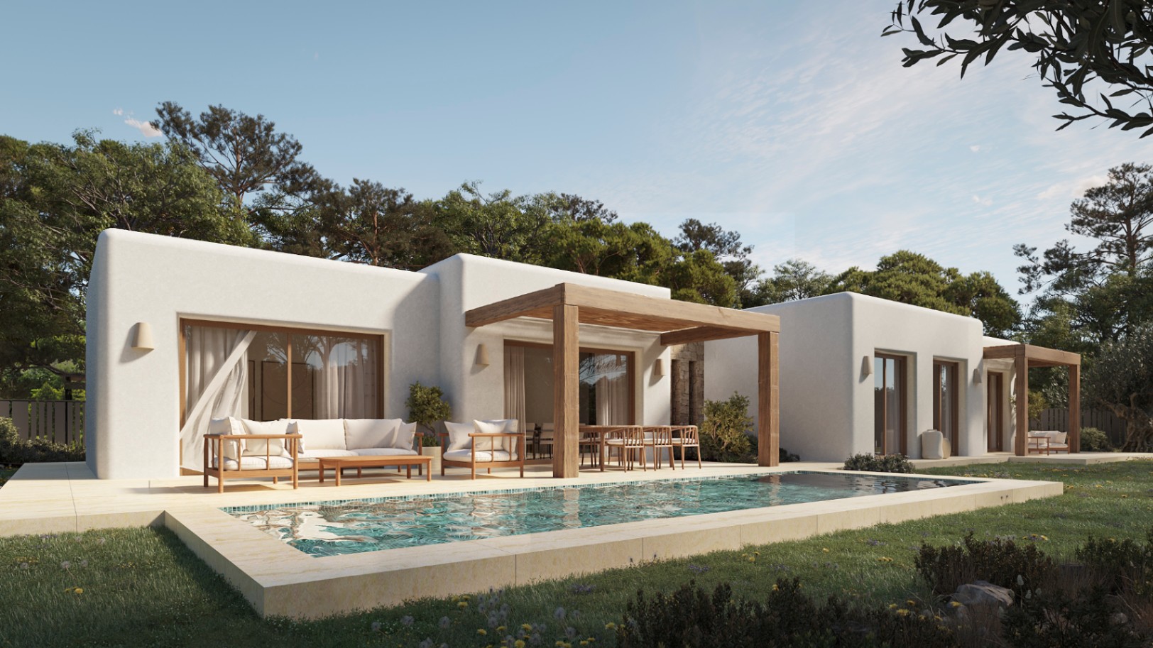 Exterior de villa ibicenca con piscina rectangular, terraza de piedra clara, pérgolas de madera y fachada de estuco blanco integrada en un entorno natural de pinos.