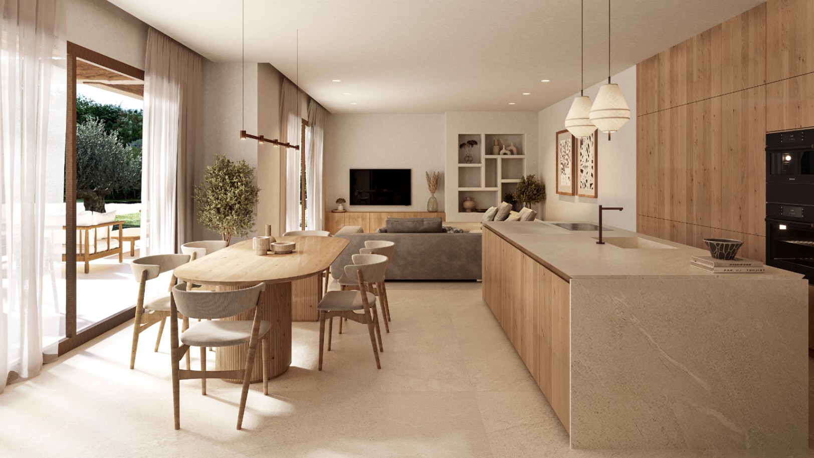 Salón-comedor diáfano con cocina integrada, isla de piedra natural y carpintería de madera. Grandes ventanales conectan el interior con la terraza y el jardín mediterráneo.