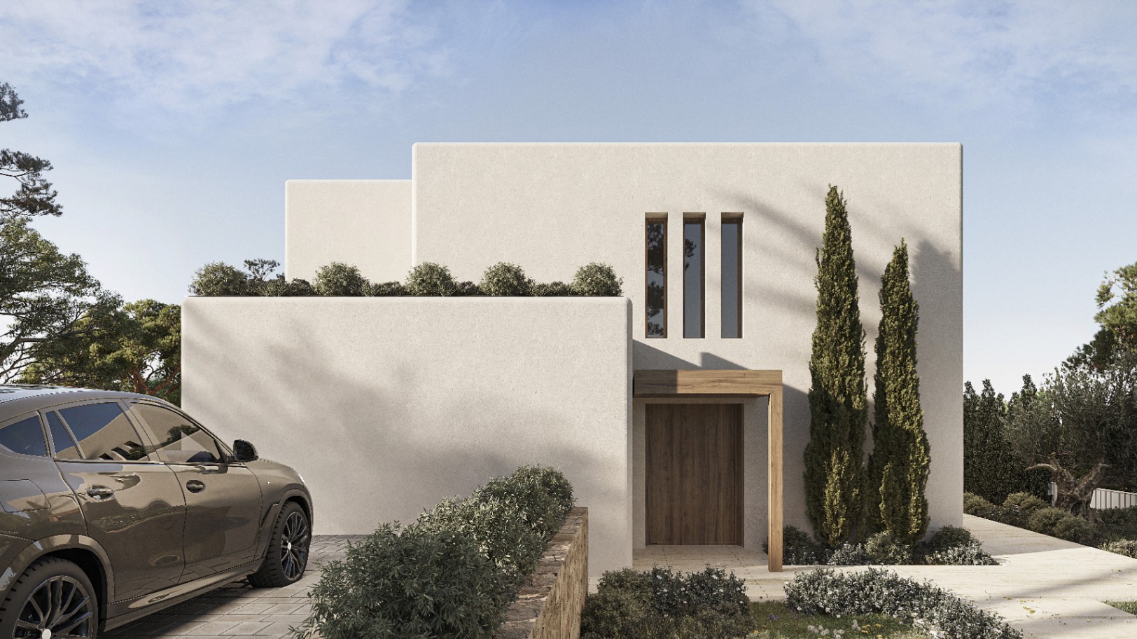 Fachada moderna de villa en Benissa con puerta de madera y vegetación cuidada.