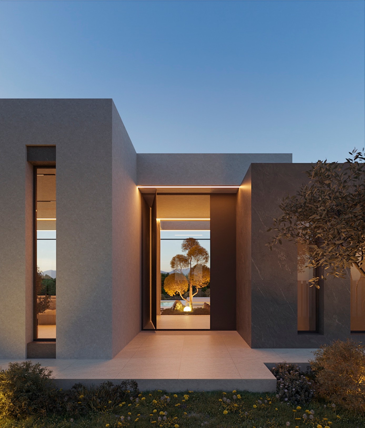 Entrada principal con puerta pivotante de gran formato e iluminación LED integrada. Fachada de líneas rectas con acabados en piedra gris y ventanales verticales.