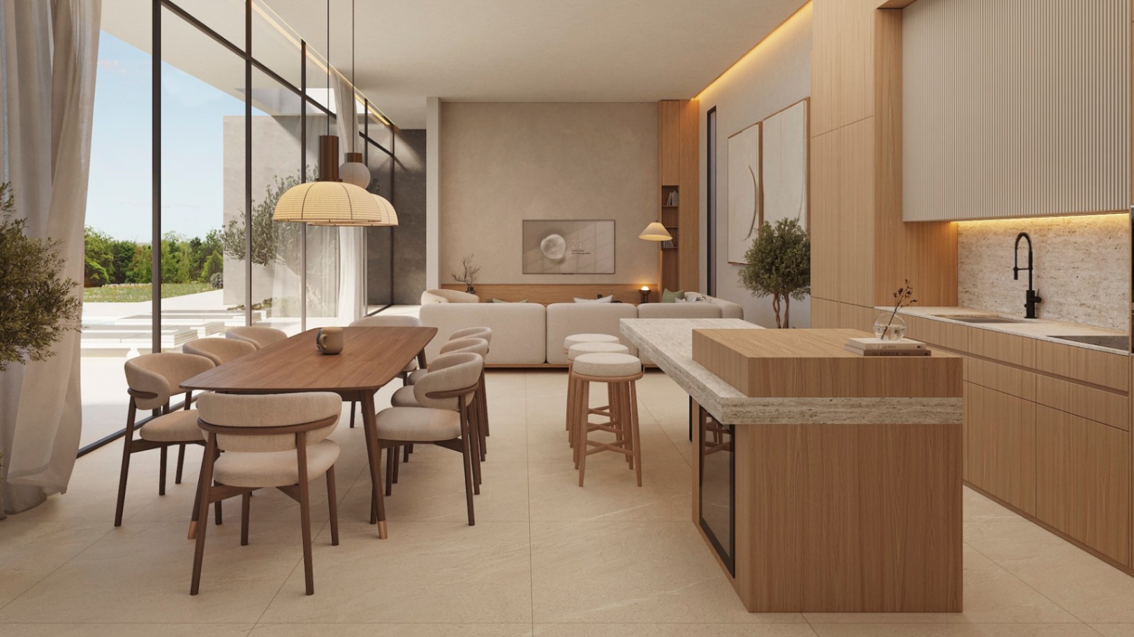 Salón-comedor diáfano con cocina integrada, acabados en madera clara, encimeras de piedra natural y grandes ventanales que conectan directamente con el jardín mediterráneo.