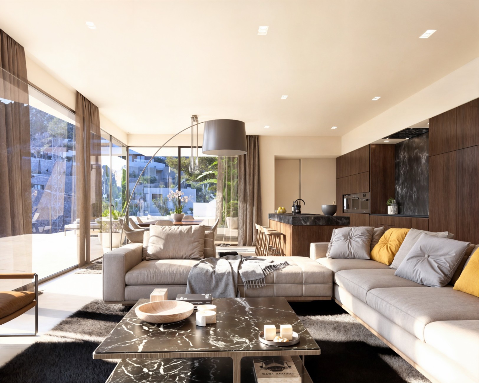 Salón de concepto abierto con sofás en tonos neutros, mesa de mármol negro y cocina integrada con armarios de madera oscura y grandes ventanales al exterior.
