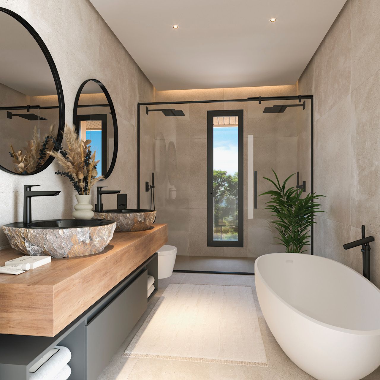 Baño principal con lavabos de piedra natural sobre encimera de madera, bañera exenta y ducha italiana con grifería negra mate y revestimientos cerámicos en tonos arena.