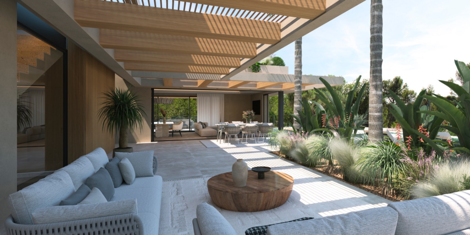 Terraza cubierta con pérgola de madera y suelos de piedra, que integra una zona de estar exterior con el salón-comedor mediante grandes ventanales.