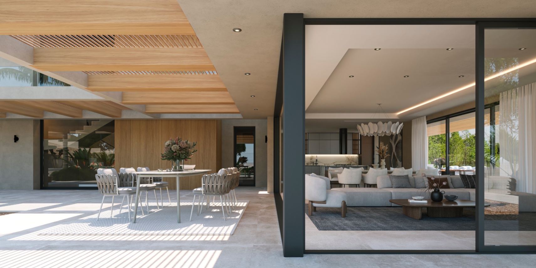 Terraza exterior con pérgola de madera y comedor, conectada mediante grandes ventanales al salón de planta abierta y cocina de diseño.