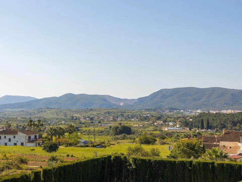Vistas panorámicas despejadas hacia el valle y las montañas de la Costa Blanca, destacando el entorno rural y la vegetación mediterránea desde la terraza.