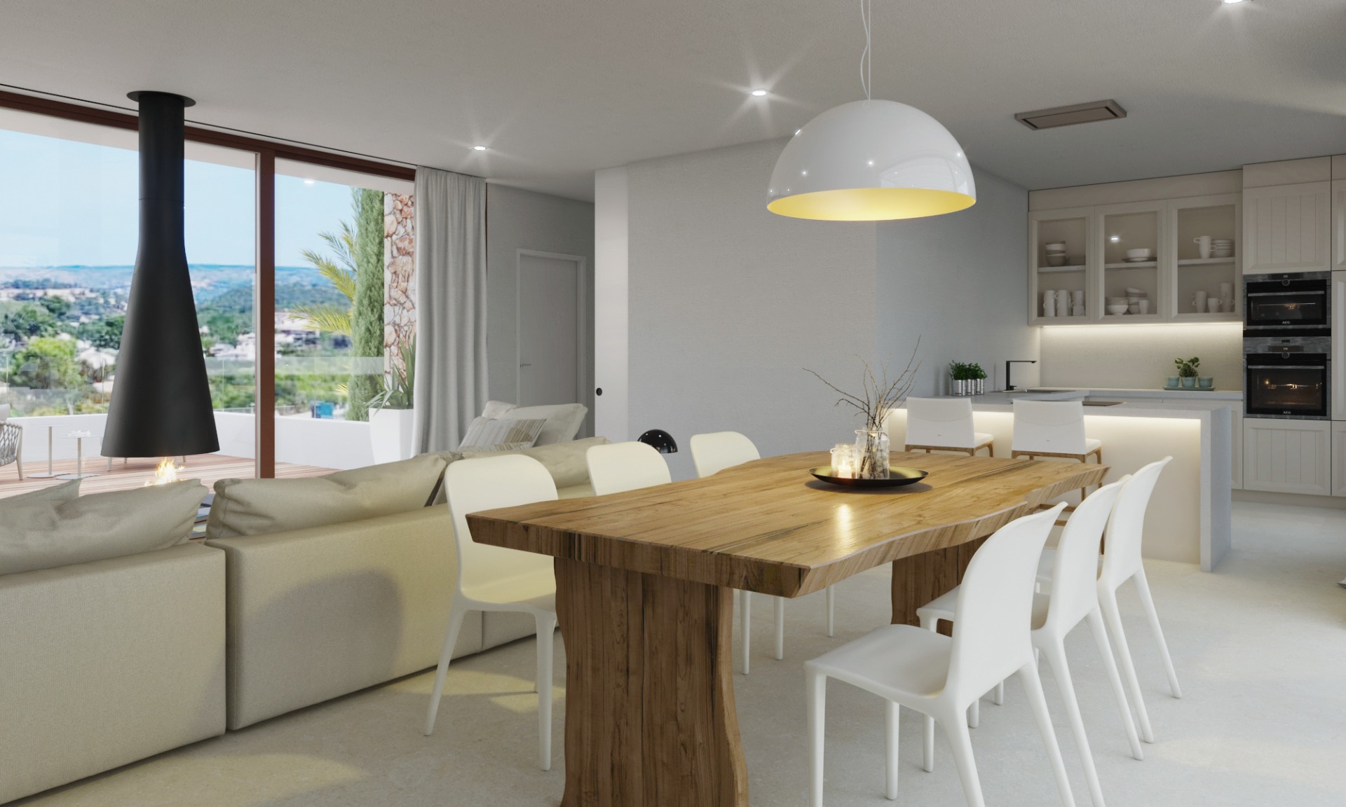 Salón-comedor de concepto abierto con mesa de madera natural, chimenea suspendida de diseño y cocina integrada con acceso directo a la terraza y vistas al valle.
